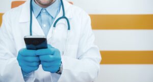 Physician Doctor Communicating Through Cell Phone.